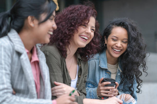istock Multi-Ethnic Female University Students Sitting Outside Together 1166509942
