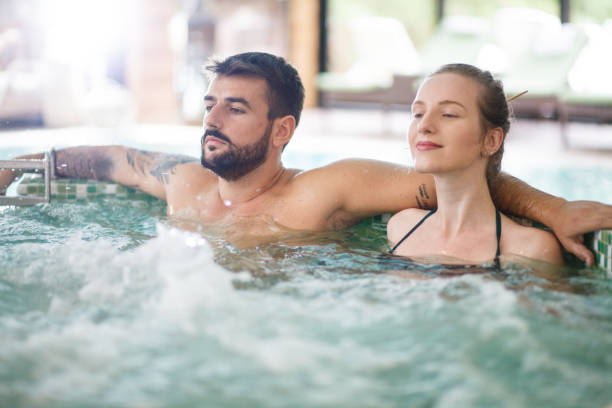 istock Couple enjoying hydro massage bath at spa 1166509956