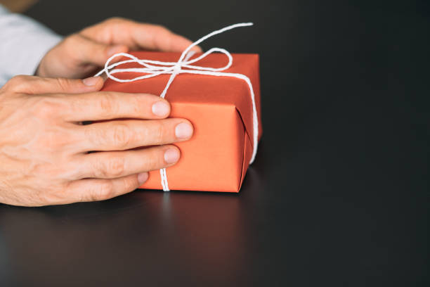istock goods delivery service red paper gift box hands 1166511105