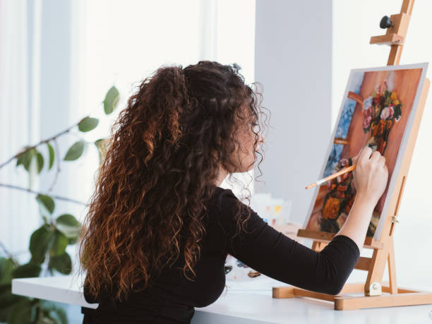 istock art hobby talented lady still life painting home 1166511155