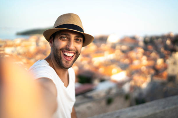 istock Tourist man taking a selfie and looking at camera 1166511614