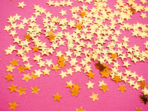 istock Golden stars glitter on pink background 1166511924