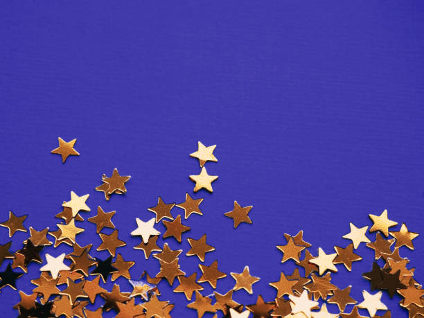 istock Golden stars glitter on violet background 1166511948
