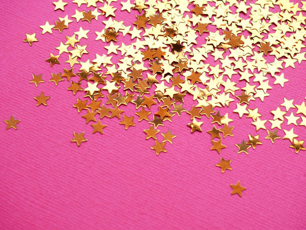 istock Golden stars glitter on pink background 1166511953