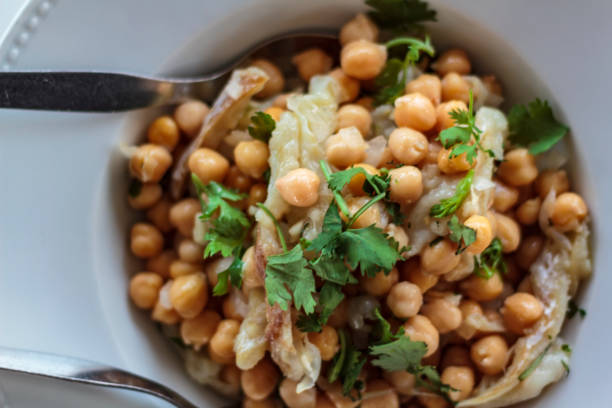 istock Top view of chickpeas salad with cod and coriander 1166512579