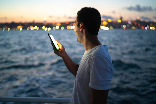Side view of a man making a video chat at a boat