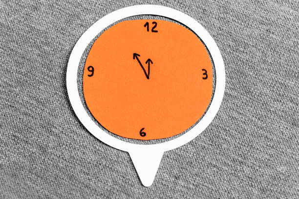 time to lunch concept. orange clock made with paper on a grey fabric textured background. - clock time alarm clock orange imagens e fotografias de stock