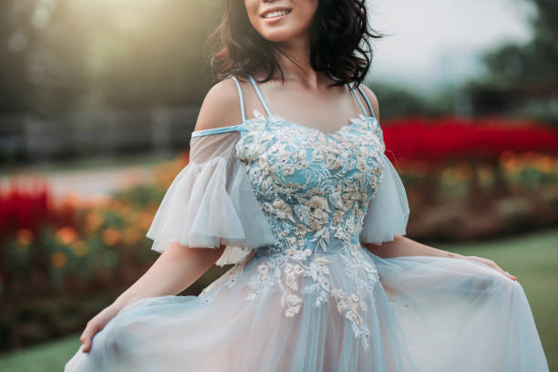 an asian chinese female model dress up with wedding gown for outdoor portrait session at public park in evening - evening gown imagens e fotografias de stock