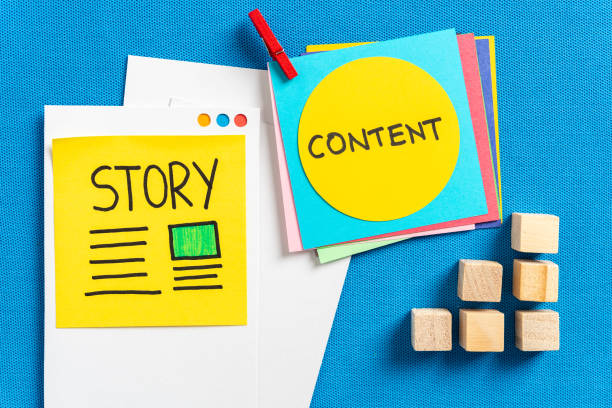 Social media content sharing, storytelling and digital marketing concept made with cut colorful papers and the illustrated words "story" and "content" and wooden block toys on blue texture background. stock photo