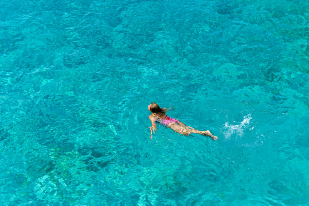istock Woman floating in immaculate sea. 1166525438