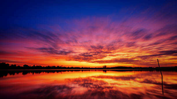 istock Beautiful sunset sky with golden dramatic light over mountain and river view. 1166526744