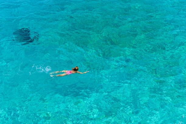 istock Woman floating in immaculate sea. 1166527943