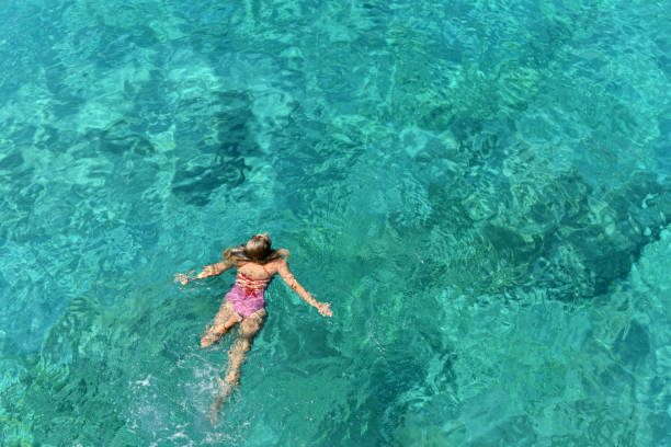 istock Woman floating in immaculate sea. 1166528874