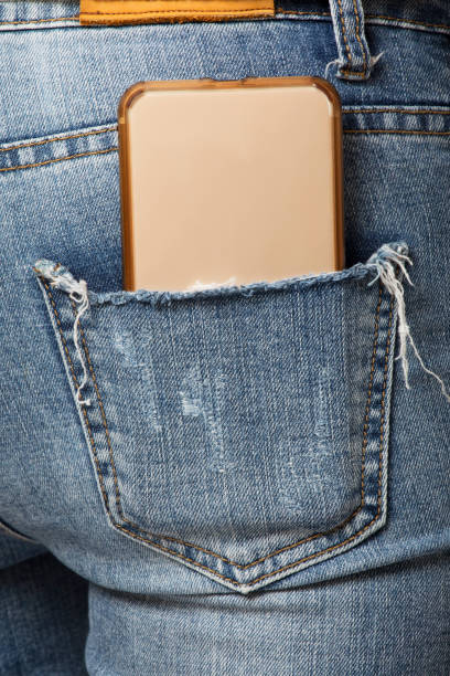 istock Woman with a cell phone in her back pocket 1166529883