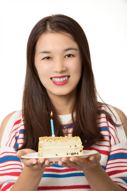 istock Asian woman holding a birthday cake 1166530491