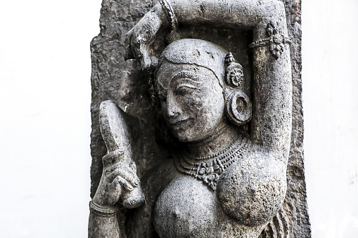 Ancient archaeological stone sculpture of a female with mirror in hand made of sandstone of sixth century common era