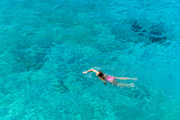 istock Woman floating in immaculate sea. 1166533979