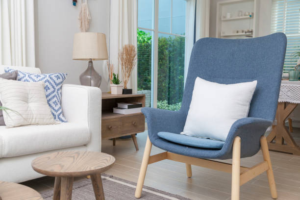 istock White sofa with many blue pillows in cozy living room. 1166534229