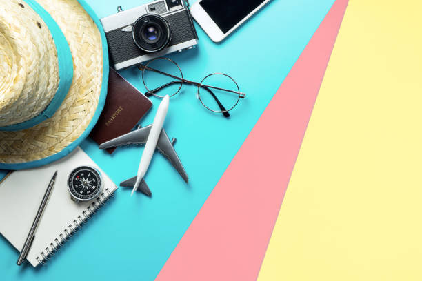 istock Travel accessories objects and gadgets top view flatlay on blue yellow pink 1166537399