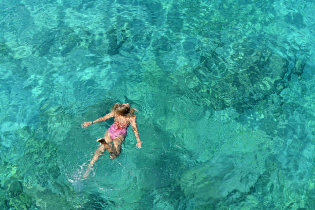 istock Woman floating in immaculate sea. 1166539355