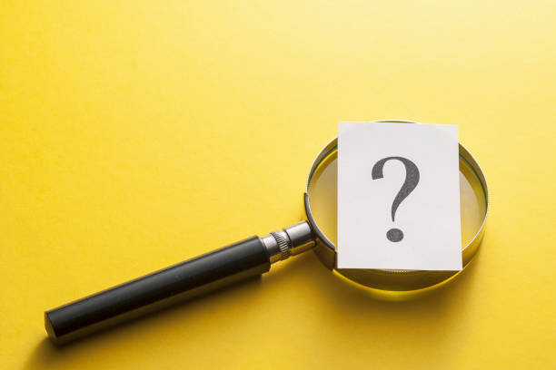 istock Magnifying glass with question mark on yellow 1166539959