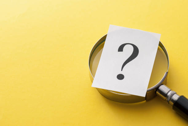 istock Printed question mark covering a magnifying glass 1166539968