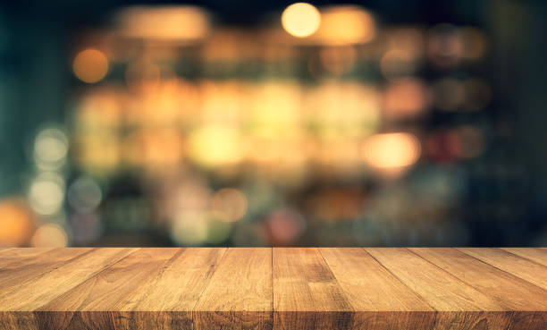 istock Wood texture table top (counter bar) with blur light gold bokeh in cafe,restaurant background 1166542661