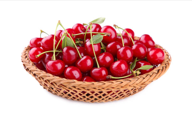 istock Cherry in wooden basket with leaves isolated on white background 1166543731