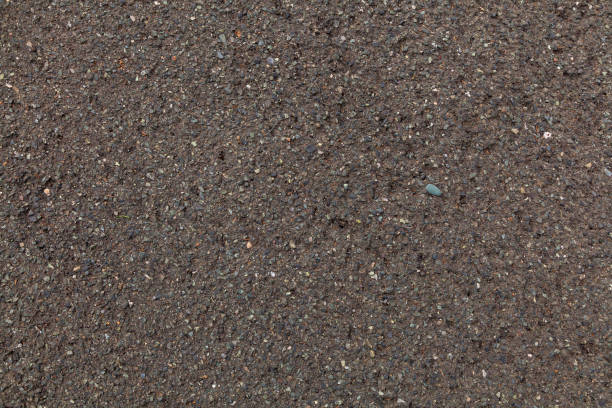istock The texture of gray dark sand, the background. 1166544839