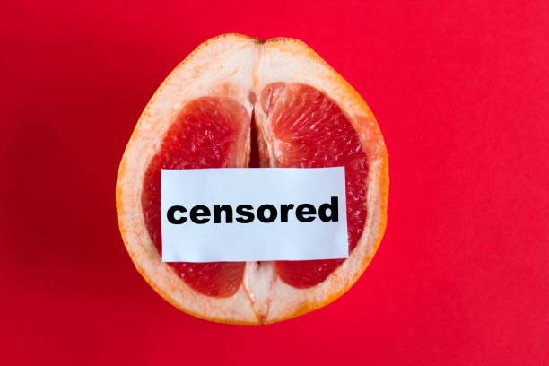 ripe juicy grapefruit  with note censored  isolated on a red background - passion sexual activity sexual issues sex imagens e fotografias de stock