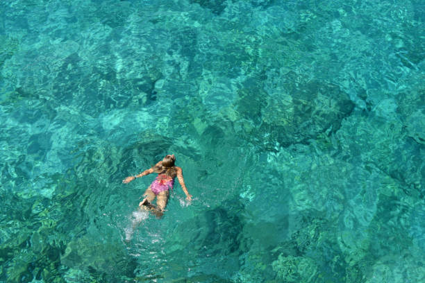 istock Woman floating in immaculate sea. 1166545879