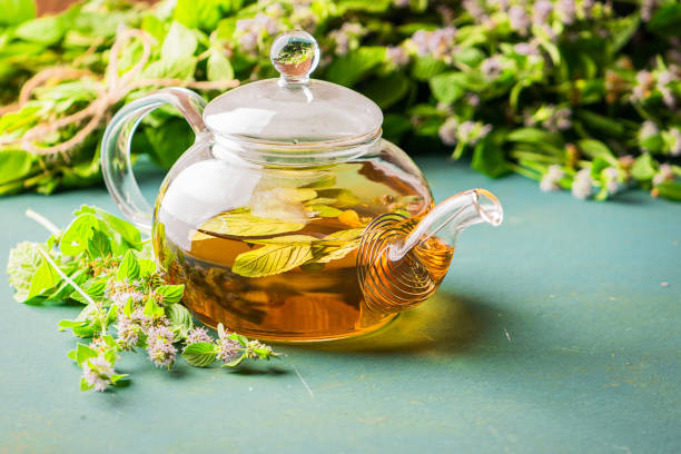 istock Fresh aromatic tea with melissa mint leaves glass teapot on a rustic background. Healing herbal drink. Horizontal frame. 1166547687