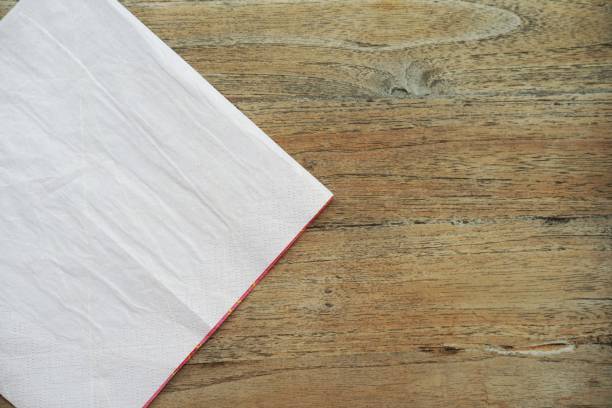 istock Napkin paper on wooden background 1166548628
