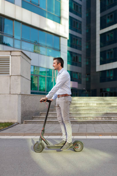 istock Young commuter enjoying ride on his push scooter 1166550076