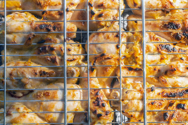 istock fried chicken legs and grill top view 1166550194