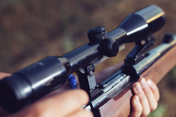 istock Woman hunter loading bullet to carbine 1166550414