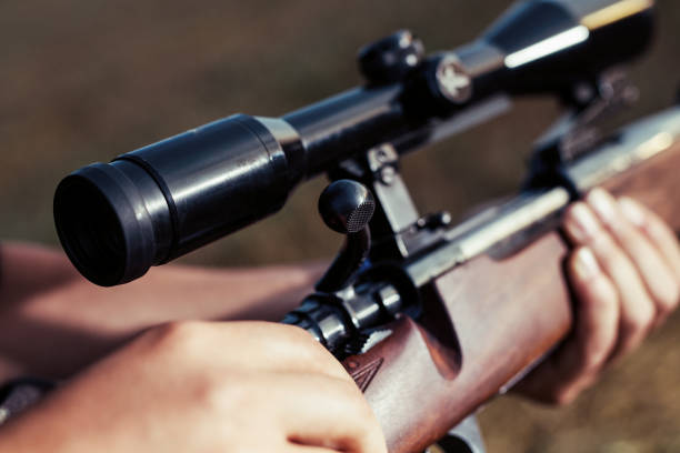 istock Woman hunter loading bullet to carbine 1166550481
