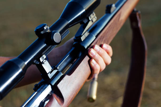 istock Woman hunter loading bullet to carbine 1166550530