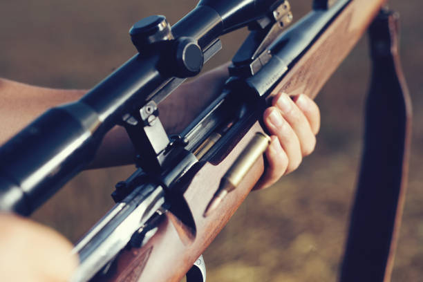 istock Woman hunter loading bullet to carbine 1166550563