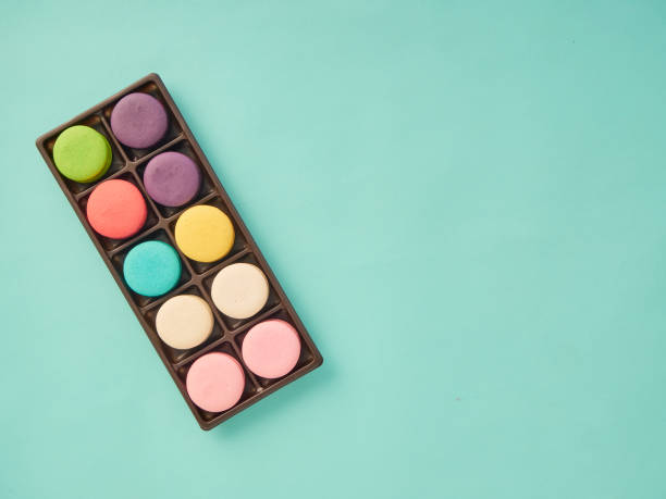 Bright colorful group of macaron on pastel blue background