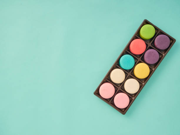 Bright colorful group of macaron on pastel blue background