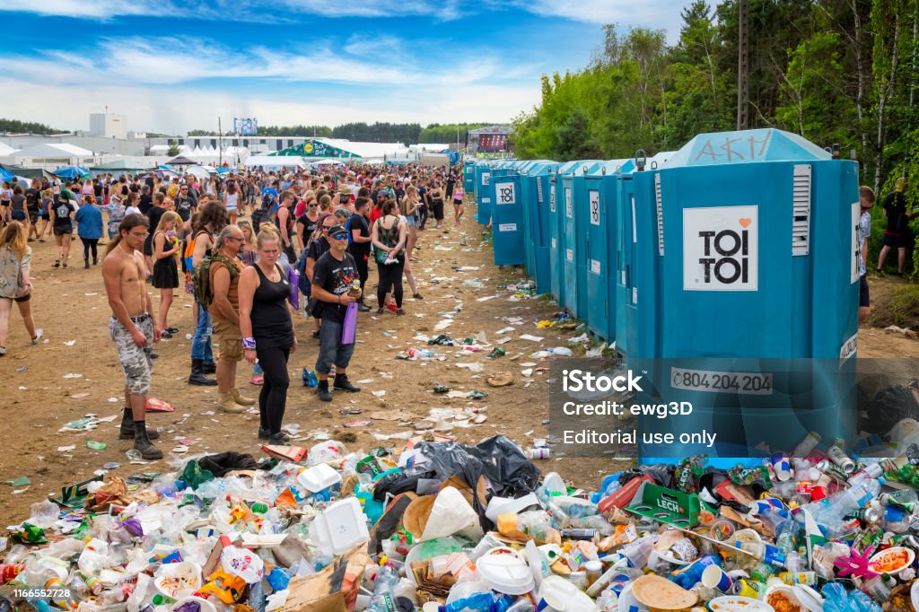Pol'and'rock Festival 2019, Poland Kostrzyn Nad Odra, Poland - August 02, 2019:Crowd of young people standing in front of portable toilets on the 25th Pol'and'rock Festival - the biggest open air ticket free rock music festival in Europe Music Festival Stock Photo