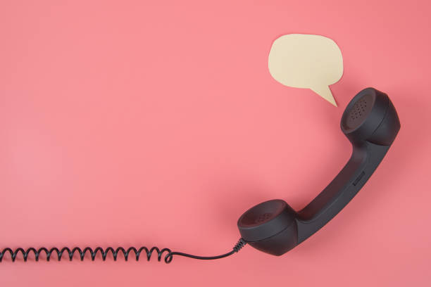 istock Handset phone with speech bubble on a pink background. 1166554914