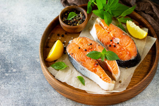 steak raw fish prepared for cooking. salmon wiht basil and spices on slate table. free space for your text. - 18797 imagens e fotografias de stock