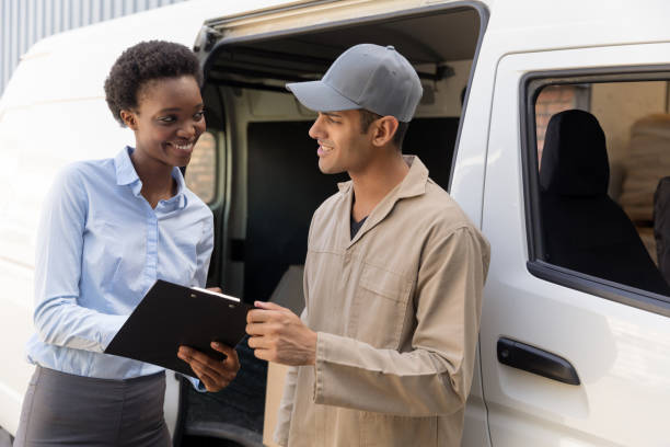 istock Delivery man and warehouse manager talking with each other outside the warehouse 1166555156