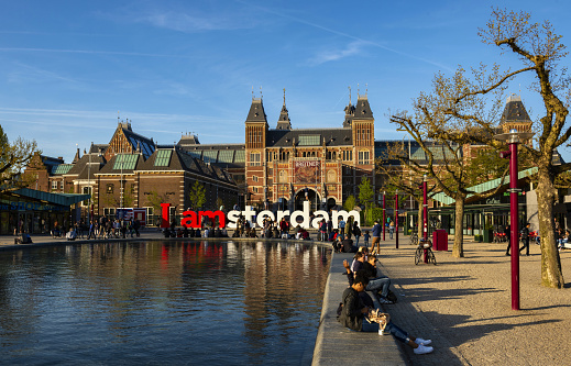 Amsterdam, Netherlands, May 5, 2016: The people enjoy the evening mood in front of the Rijksmuseum. The Rijksmuseum is  Dutch national museum dedicated to arts and history in Amsterdam.