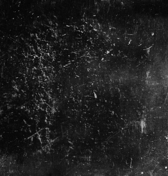 istock Scratched surface of a black and white film 1166557616