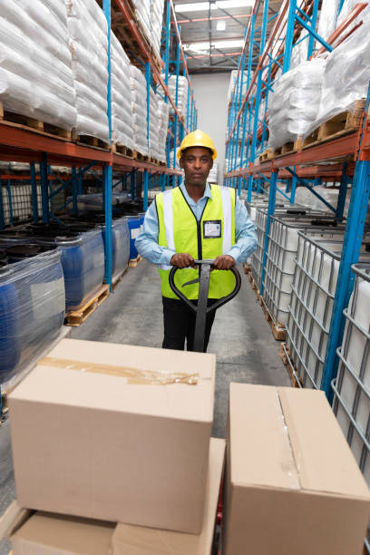 istock Male staff using pallet jack in warehouse 1166560162