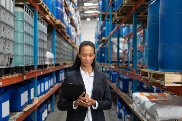istock Female manager standing with clipboard in warehouse 1166560564
