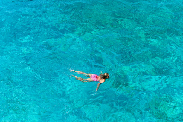 istock Woman floating in immaculate sea. 1166561224